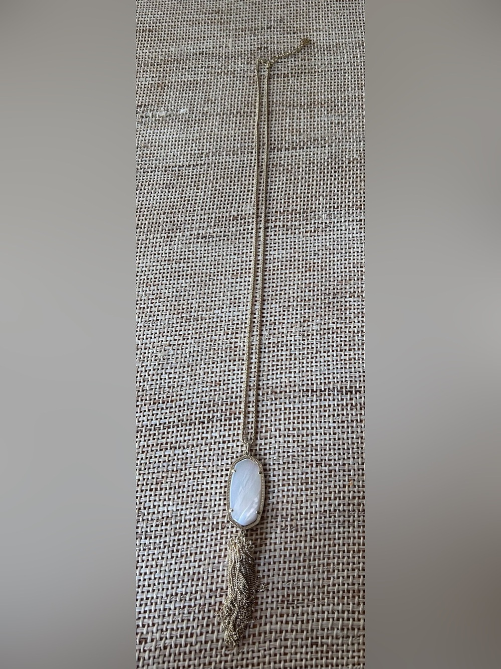 Kendra Scott Rayne Gold Tone Tassle Necklace with Pearlized White Detail.